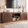 Fluted walnut TV stand with enclosed storage in a living room