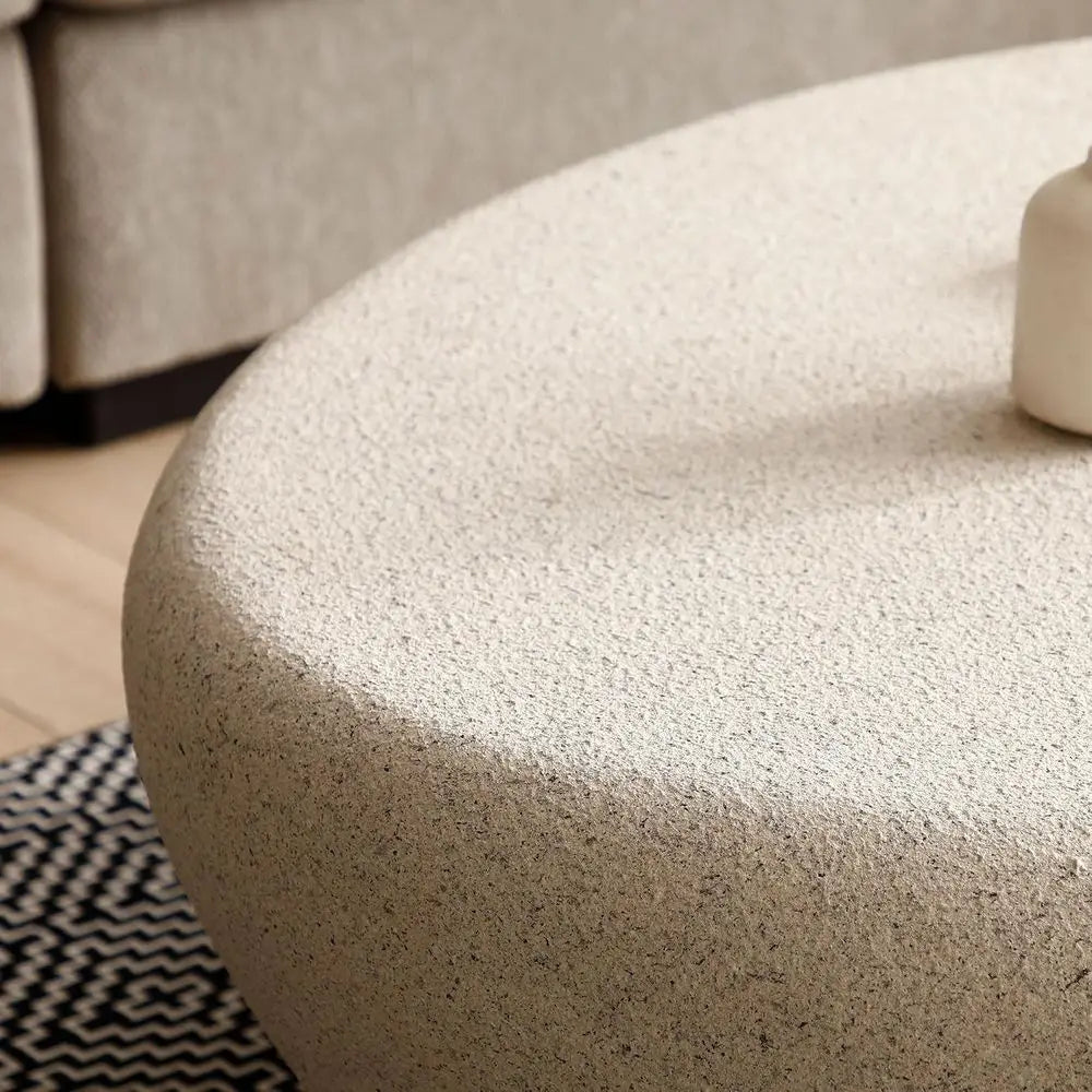 Oval stone coffee table — side detail view